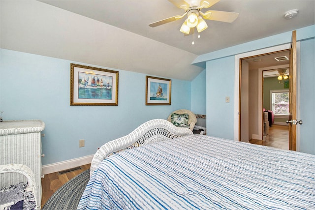 bedroom with hardwood / wood-style flooring, ceiling fan, and lofted ceiling