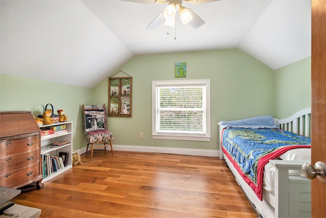 bedroom with ceiling fan, lofted ceiling, and hardwood / wood-style flooring