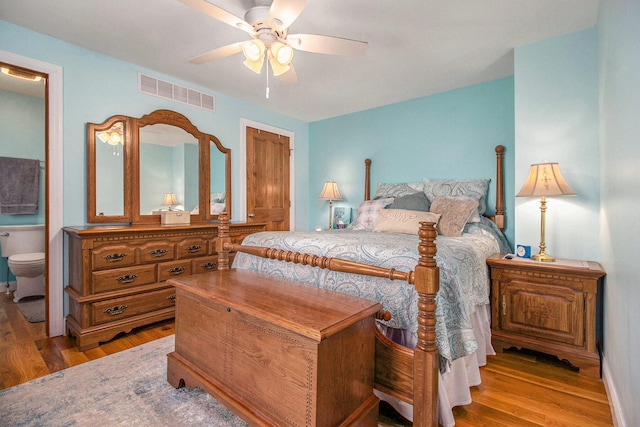 bedroom featuring ensuite bath, ceiling fan, and light hardwood / wood-style floors