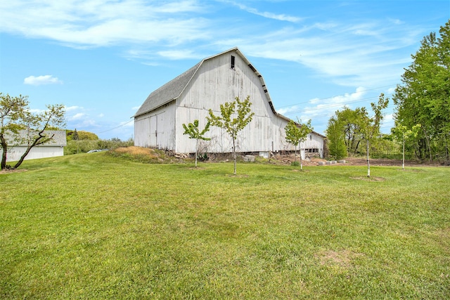 view of property exterior featuring an outbuilding and a yard