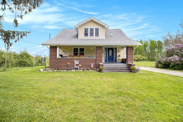 bungalow-style home featuring covered porch and a front lawn