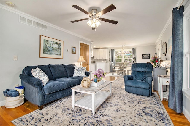 living room featuring light hardwood / wood-style floors and ornamental molding