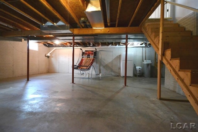 basement featuring white fridge