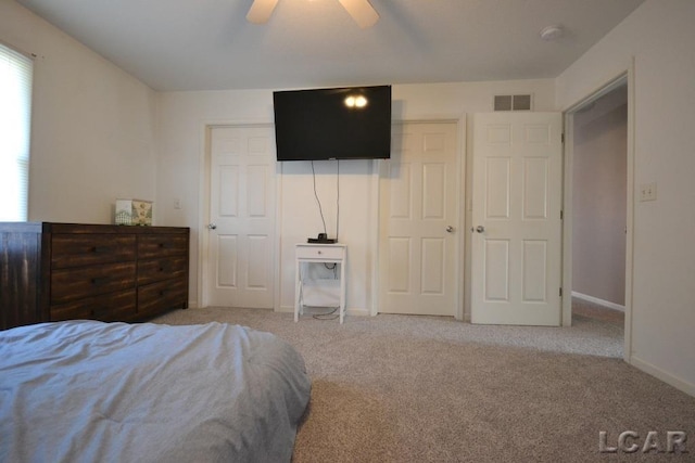 bedroom featuring ceiling fan and light carpet