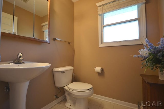 bathroom featuring tile patterned floors, toilet, and sink