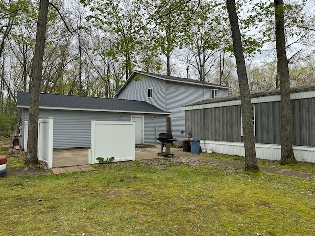 back of house with a lawn