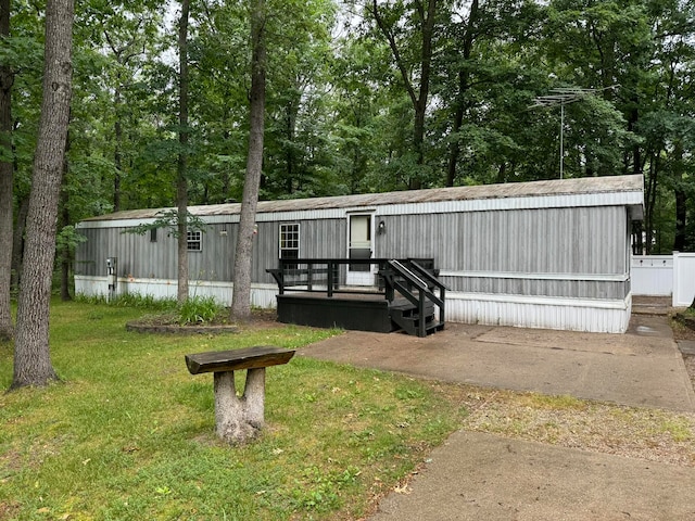 exterior space featuring a lawn and a deck