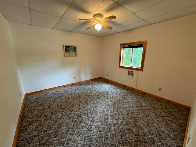 empty room featuring carpet, a drop ceiling, and ceiling fan