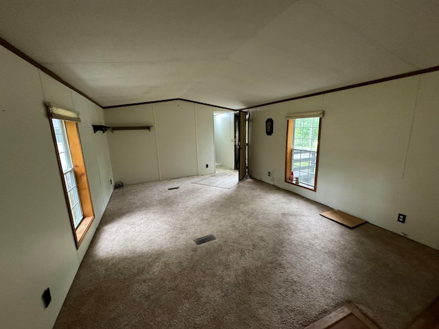 unfurnished room with lofted ceiling, light carpet, and ornamental molding