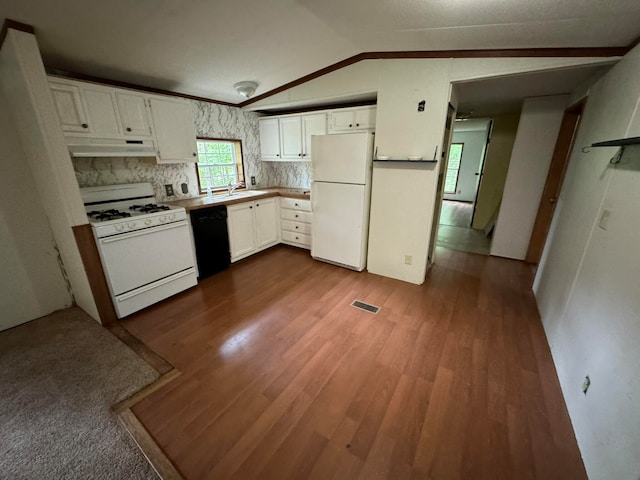 kitchen with white cabinets, wood-type flooring, white appliances, and vaulted ceiling