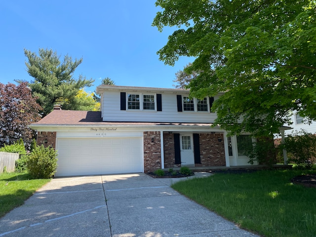 view of front of property with a garage and a front lawn