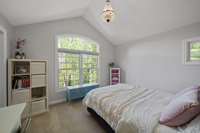 bedroom with vaulted ceiling, light colored carpet, and multiple windows