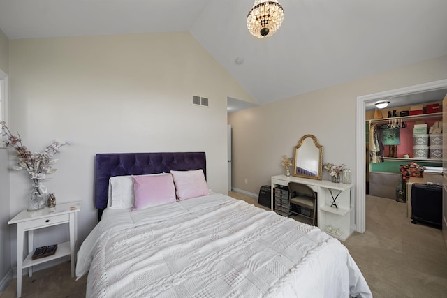 carpeted bedroom with a walk in closet, a closet, and lofted ceiling