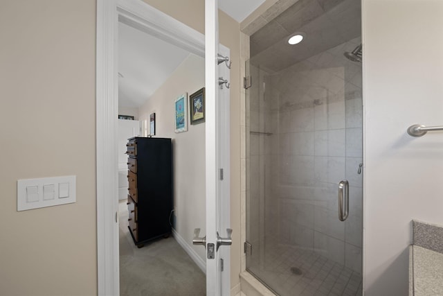 bathroom with lofted ceiling and walk in shower