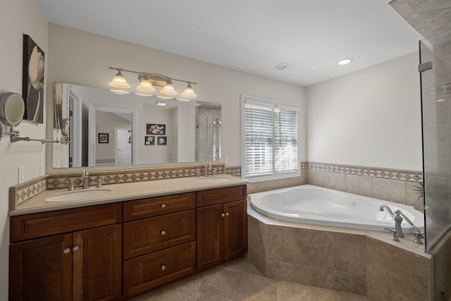 bathroom with tile patterned flooring, vanity, and separate shower and tub