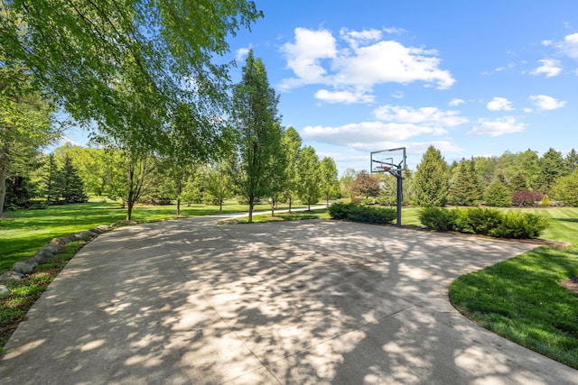 view of basketball court featuring a lawn