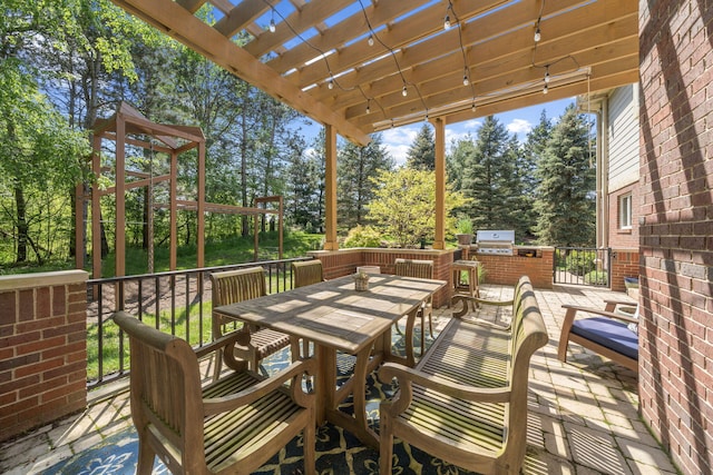 view of patio / terrace with a pergola, area for grilling, and a grill