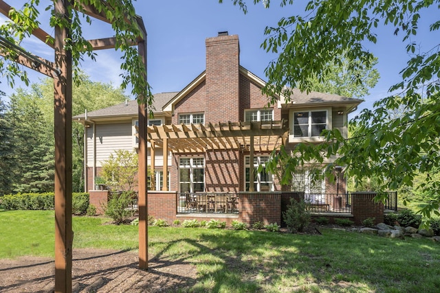 back of house with a pergola and a yard