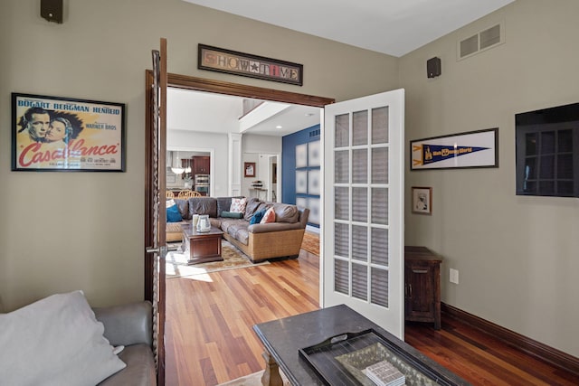 living room featuring hardwood / wood-style floors and decorative columns