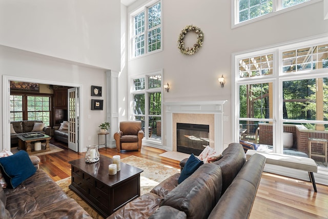 living room featuring a high ceiling and light hardwood / wood-style flooring