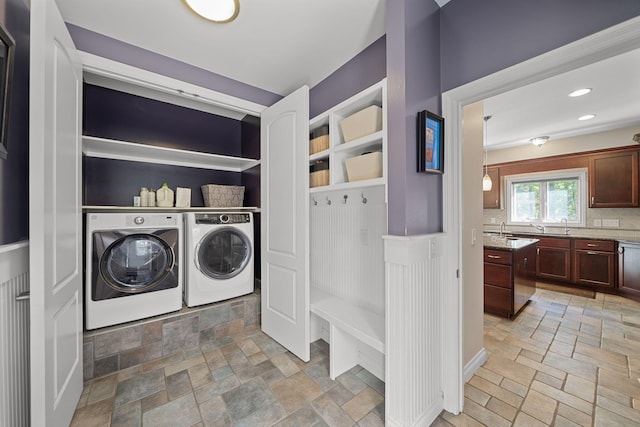 washroom with washer and dryer and sink