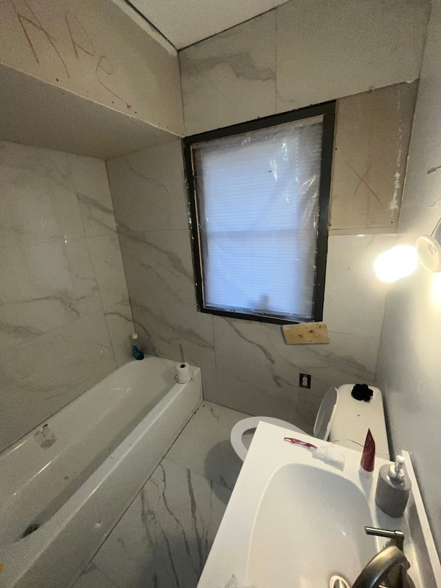 bathroom with toilet, sink, tile walls, and a washtub