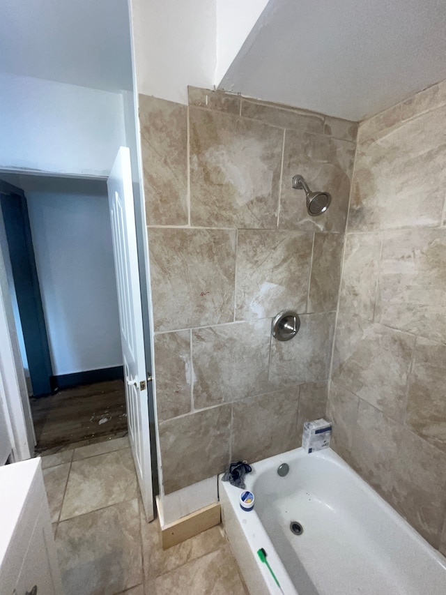 bathroom featuring tile patterned flooring and tiled shower / bath combo