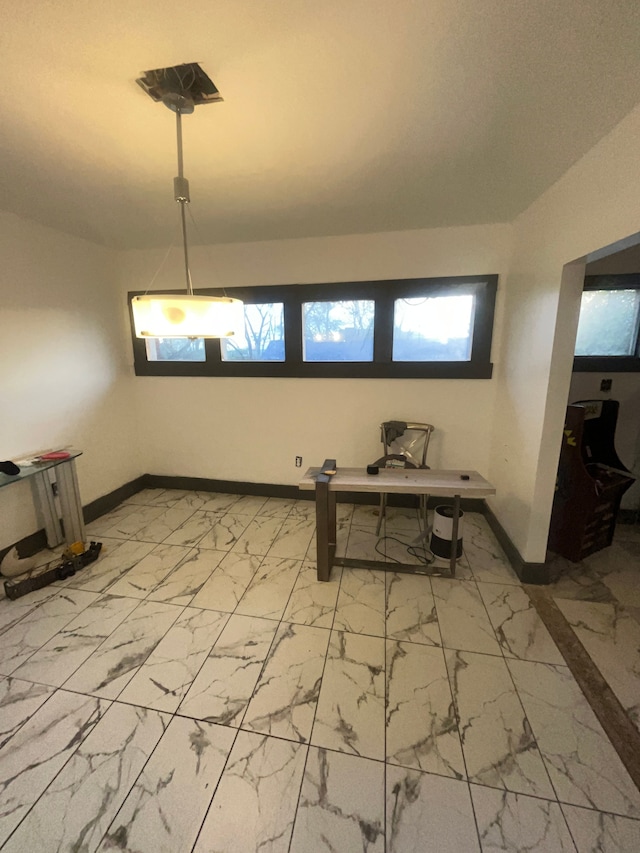 dining room featuring marble finish floor and baseboards