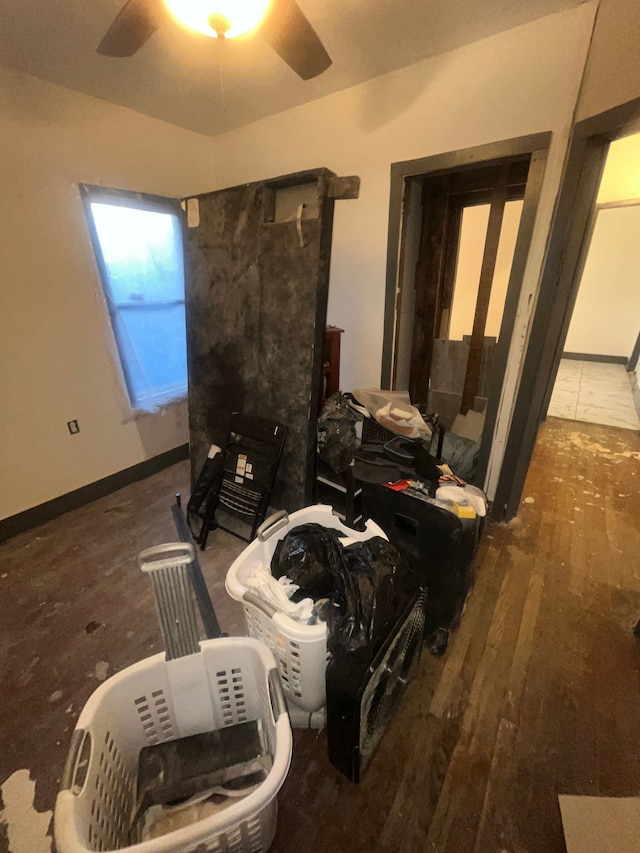 interior space with ceiling fan, baseboards, and wood finished floors