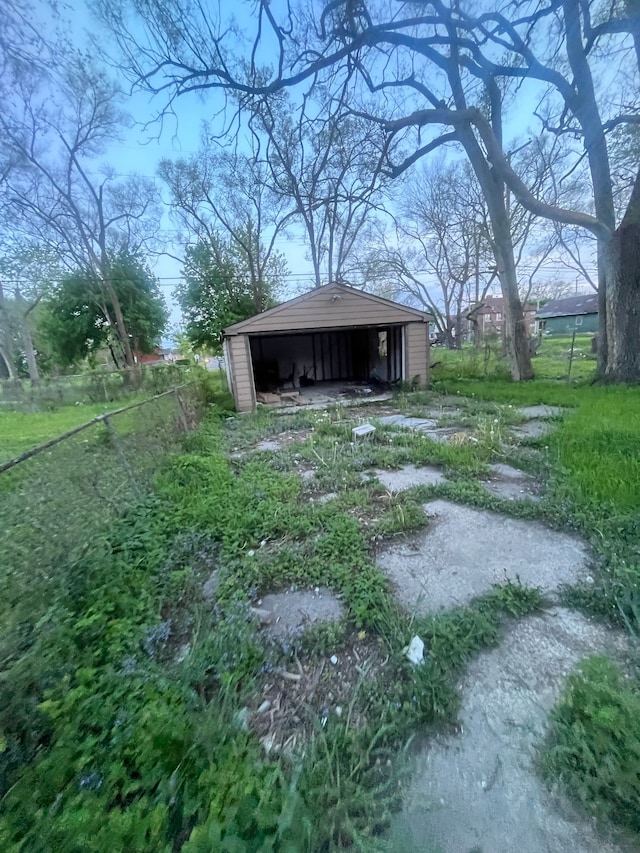 view of yard featuring a pole building, an outdoor structure, and a detached garage