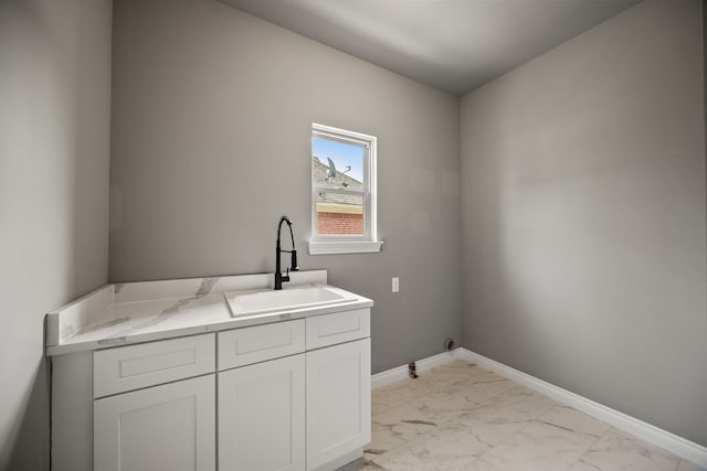 35873 Glenville Dr, New Baltimore, MI 48047 - washroom featuring baseboards, marble finish floor, a sink, and cabinet space