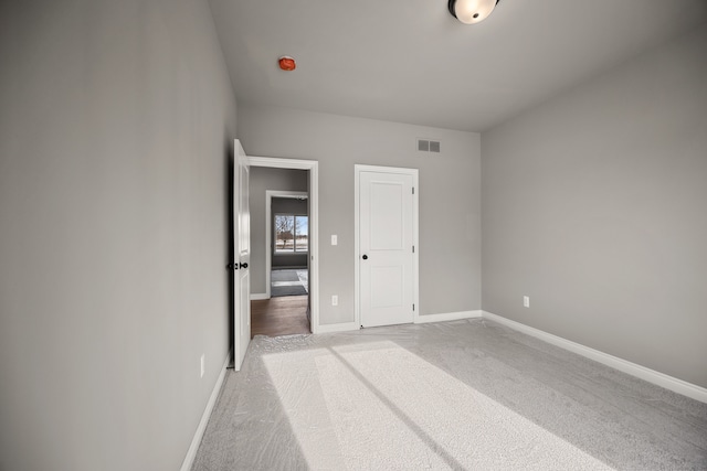 35873 Glenville Dr, New Baltimore, MI 48047 - unfurnished bedroom with baseboards, visible vents, and carpet floors