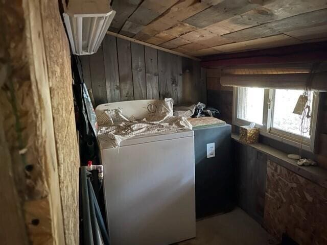 laundry room with washer / clothes dryer, wooden ceiling, and wood walls