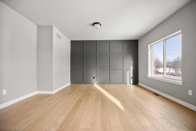 empty room with light hardwood / wood-style flooring