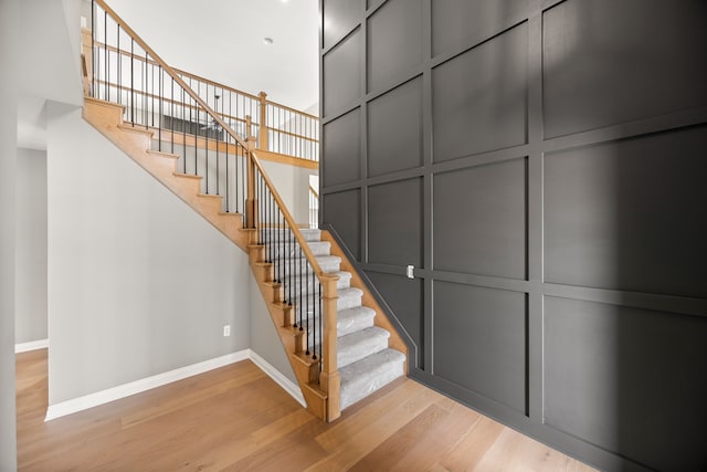 staircase featuring wood-type flooring