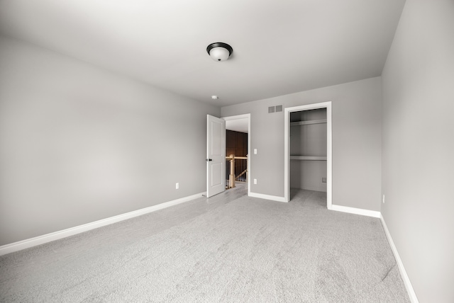 unfurnished bedroom featuring carpet flooring and a closet