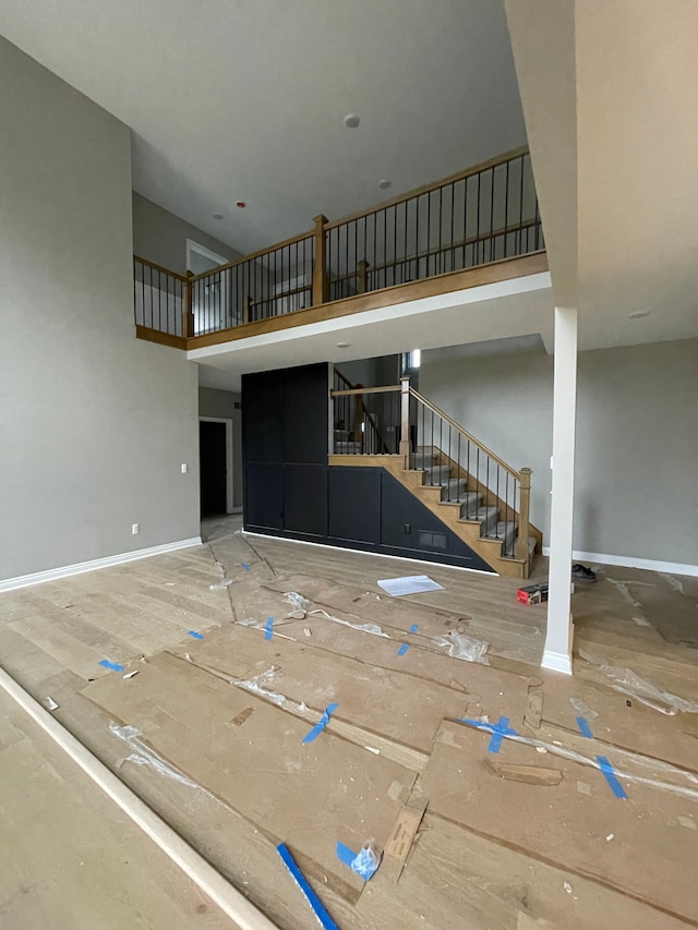 unfurnished living room with a high ceiling