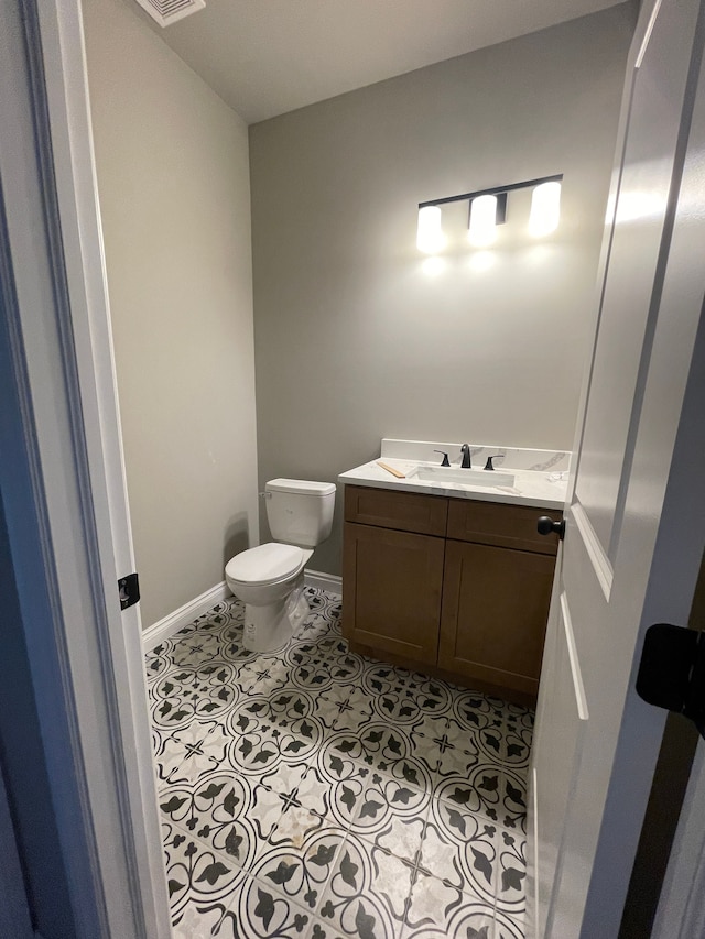 bathroom featuring vanity and toilet