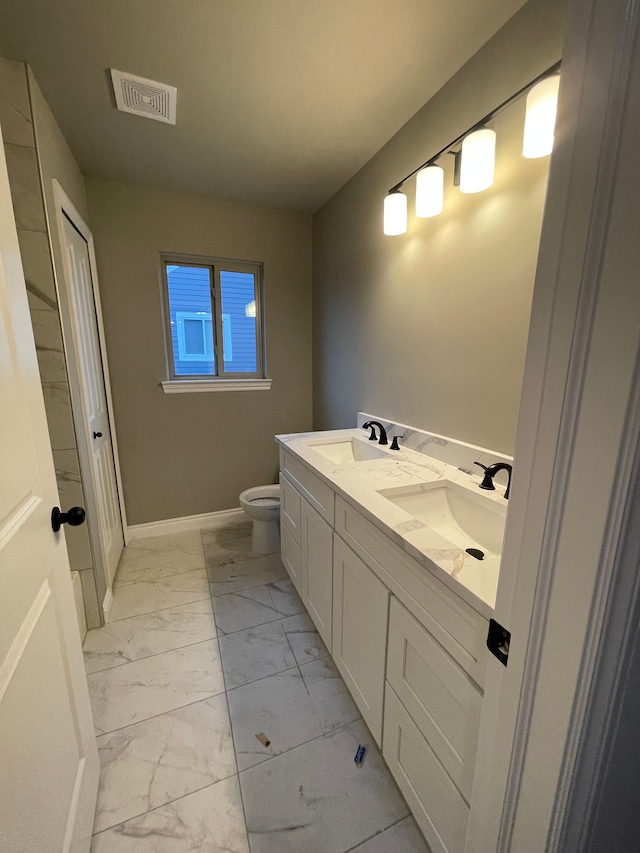 bathroom featuring vanity and toilet