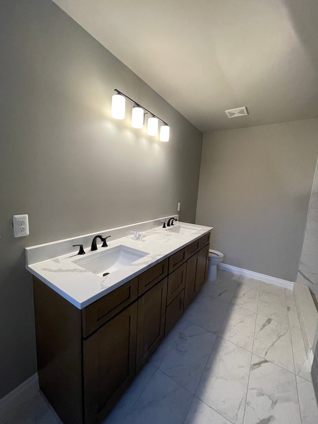 bathroom with vanity and toilet