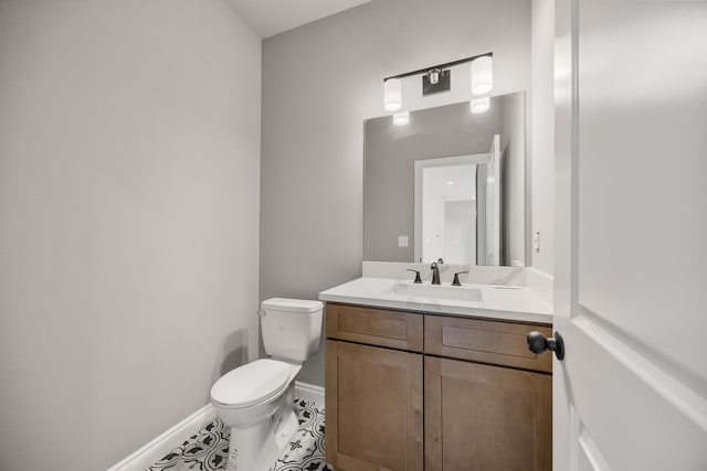 bathroom featuring vanity, toilet, and tile patterned flooring