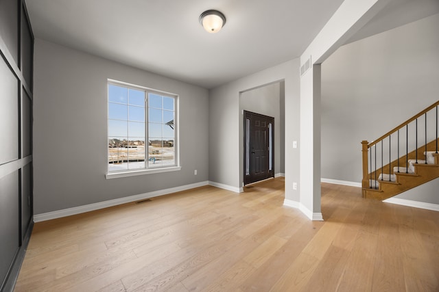 foyer entrance with light hardwood / wood-style floors