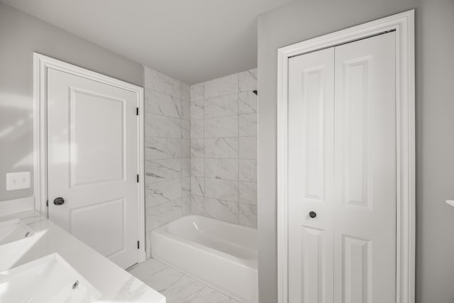 bathroom with vanity and tiled shower / bath combo