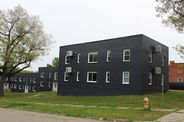 view of building exterior with an AC wall unit