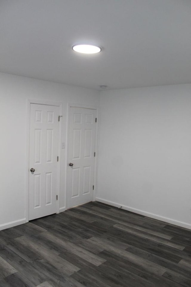 empty room featuring dark hardwood / wood-style flooring