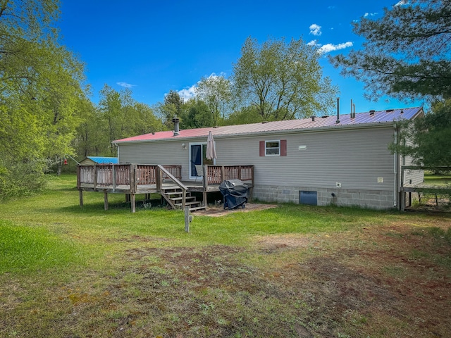 back of house with a lawn and a deck