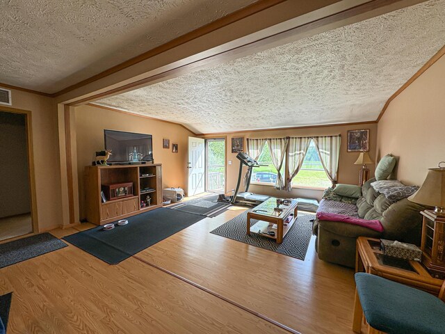 2314 Revolt Rd, Manistee, MI 49660 - living room with a textured ceiling, wood finished floors, and crown molding