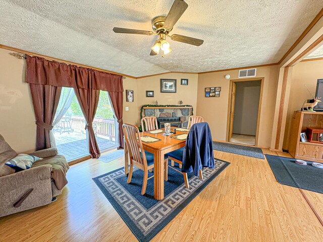 2314 Revolt Rd, Manistee, MI 49660 - dining room with light wood finished floors, ornamental molding, ceiling fan, and a textured ceiling