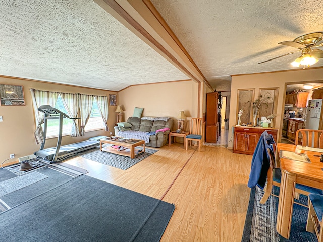 living room with hardwood / wood-style flooring, ornamental molding, and a textured ceiling