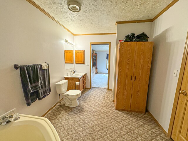 2314 Revolt Rd, Manistee, MI 49660 - bathroom with ornamental molding, toilet, a textured ceiling, vanity, and baseboards
